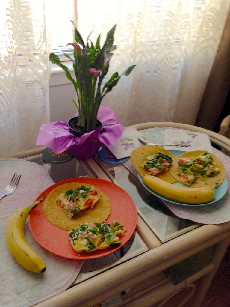Breakfast table with flowers and curtains