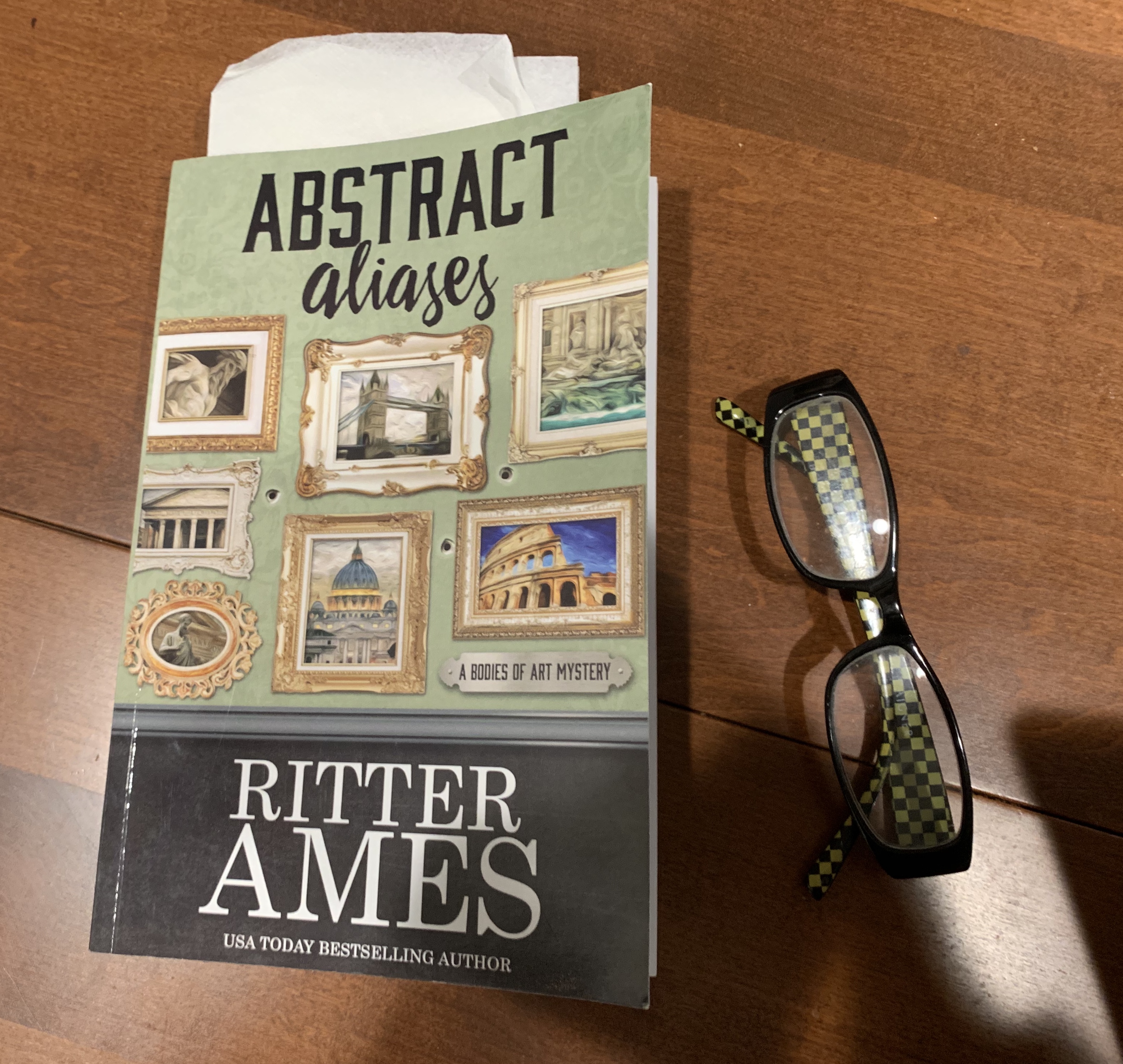 My paperback copy of Astract Aliases by Ritter Ames

Ritter’s site page with links to all available vendors & versions
( paper, hard cover, ebook - Amazon, Kobo, B&N, Apple, Google )

https://ritterames.com/books/abstract-aliases/
