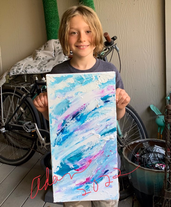 Max holding panel 1 of 4 of "Mountains Clouds and Waves" ©Felipe Adan Lerma March 2022