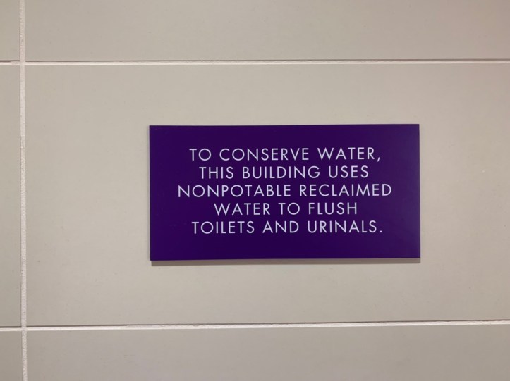 Environmentally sensitive bathroom wall plaque info at the Austin Public Library - https://library.austintexas.gov/central-library