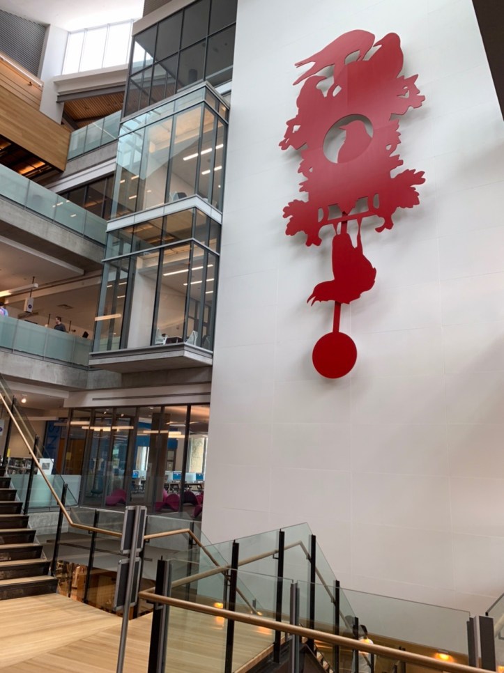 Vistas & decorative red silhouette clock with birds at the Austin Public Library - https://library.austintexas.gov/central-library