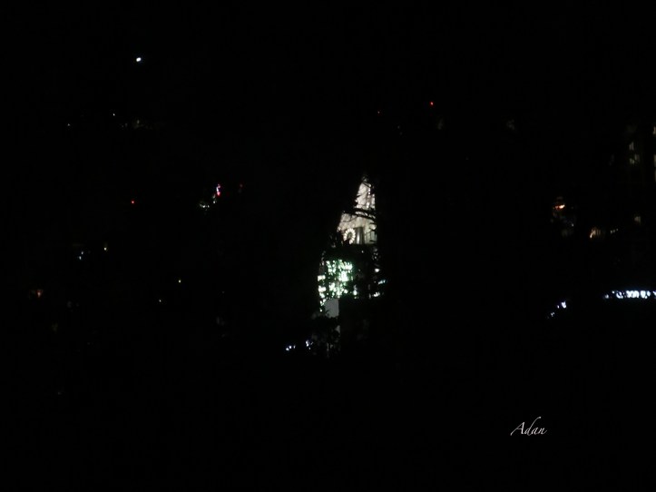 Fireworks, seen through the trees between our balcony & downtown, reflecting off the Frost Tower, Austin Texas - the 4th of July 2022 ©Felipe Adan Lerma