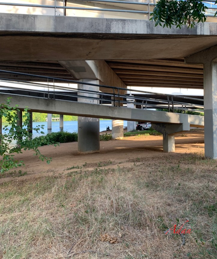 Man fishing under freeway structure, summer, Austin Texas 2022 ©Felipe Adan Lerma